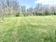Spacious backyard with lush green grass and mature trees, perfect for outdoor activities at 2303 Cole Wood Ct, Indianapolis, IN 46239