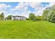 Lush backyard featuring a well-maintained lawn and mature trees, offering privacy at 2303 Cole Wood Ct, Indianapolis, IN 46239