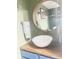 Stylish bathroom featuring a vessel sink, wood countertop, and round mirror for a modern touch at 2303 Cole Wood Ct, Indianapolis, IN 46239