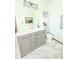 Bright bathroom featuring modern vanity, countertop, and a built-in storage unit at 2303 Cole Wood Ct, Indianapolis, IN 46239