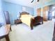 Bedroom with a wooden bed frame, soft carpet, and natural light from the windows at 2303 Cole Wood Ct, Indianapolis, IN 46239