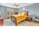 Serene bedroom featuring warm wood furniture, bright yellow bedding, and natural light at 2303 Cole Wood Ct, Indianapolis, IN 46239