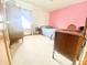 Bedroom with a pink accent wall, cozy bed, and vintage wooden furniture at 2303 Cole Wood Ct, Indianapolis, IN 46239