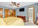 This is a bedroom with a ceiling fan and a TV hanging on the wall at 2303 Cole Wood Ct, Indianapolis, IN 46239