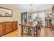 Elegant dining room with hardwood floors, a decorative cabinet, and natural light from the nearby window at 2303 Cole Wood Ct, Indianapolis, IN 46239