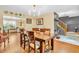 Stylish dining room featuring a wooden table, hardwood floors, and an adjacent sitting area with bright natural light at 2303 Cole Wood Ct, Indianapolis, IN 46239
