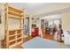 Bright dining room with hardwood floors seamlessly connects to a craft room, perfect for entertaining and hobbies at 2303 Cole Wood Ct, Indianapolis, IN 46239