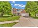 Traditional two-story home featuring a brick facade, attached two car garage, and well-maintained landscaping at 2303 Cole Wood Ct, Indianapolis, IN 46239