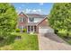 Charming brick and siding home with well-maintained landscaping and a spacious driveway at 2303 Cole Wood Ct, Indianapolis, IN 46239