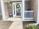 Inviting front porch with a decorative wreath, rocking chair, and flower arrangements, creating a welcoming entrance at 2303 Cole Wood Ct, Indianapolis, IN 46239