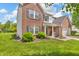 Charming two-story brick home with landscaped front yard and attached garage at 2303 Cole Wood Ct, Indianapolis, IN 46239