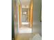 Hallway featuring neutral paint, white carpet, and wooden doors at 2303 Cole Wood Ct, Indianapolis, IN 46239
