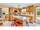 Eat-in kitchen with wood cabinets, marble-topped island and stainless-steel appliances at 2303 Cole Wood Ct, Indianapolis, IN 46239