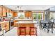 Charming eat-in kitchen with oak cabinets, island, and stainless-steel appliances leads to backyard at 2303 Cole Wood Ct, Indianapolis, IN 46239