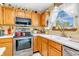 Charming eat-in kitchen with oak cabinets, stainless-steel appliances and backyard access at 2303 Cole Wood Ct, Indianapolis, IN 46239