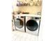 Well-equipped laundry room with modern LG washer and dryer units and ample shelving for storage at 2303 Cole Wood Ct, Indianapolis, IN 46239