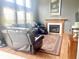 Comfortable living room with a fireplace, large window, and leather seating, creating a cozy atmosphere at 2303 Cole Wood Ct, Indianapolis, IN 46239