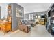 Comfortable living room area with plush seating, neutral carpet, and vintage arcade game at 2303 Cole Wood Ct, Indianapolis, IN 46239