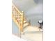 Carpeted staircase with wooden banister and a decorative table with candles at 2303 Cole Wood Ct, Indianapolis, IN 46239