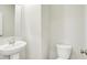 Modern half bathroom with a pedestal sink, elongated toilet, and neutral paint at 2764 Glade Ave, Plainfield, IN 46168