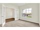 Well-lit bedroom featuring neutral carpet, a large window, and french doors to another room at 2764 Glade Ave, Plainfield, IN 46168