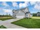 Charming gray home featuring a long driveway, well-manicured lawn, and lush landscaping at 2764 Glade Ave, Plainfield, IN 46168