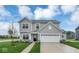 Charming two-story home featuring stone accents, a well-manicured lawn and a two car garage at 2764 Glade Ave, Plainfield, IN 46168