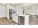 Modern kitchen with stainless steel appliances, white island with dishwasher, and hardwood floors at 2764 Glade Ave, Plainfield, IN 46168