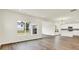 Open living area featuring wood floors, views of the backyard, and an open kitchen at 2764 Glade Ave, Plainfield, IN 46168