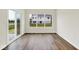 Bright room featuring hardwood floors, white trim, and large windows with backyard views at 2764 Glade Ave, Plainfield, IN 46168