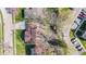 An overhead view of a well-kept suburban home with healthy grass and mature trees on a sunny day at 2815 Kay Ellen Dr, Indianapolis, IN 46229