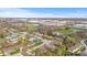 A sunny day aerial view highlights a suburban neighborhood near businesses and a church at 2815 Kay Ellen Dr, Indianapolis, IN 46229