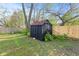Backyard with a wooden storage shed in a fenced yard, offering practical outdoor storage solutions at 2815 Kay Ellen Dr, Indianapolis, IN 46229