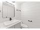 Clean bathroom with modern fixtures, shiplap walls, floating vanity and a sleek, rectangular mirror at 2815 Kay Ellen Dr, Indianapolis, IN 46229