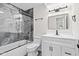 Modern bathroom with marbled shower, white vanity, and black accents at 2815 Kay Ellen Dr, Indianapolis, IN 46229