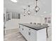 Bright kitchen with a large island, modern lighting, and stainless steel appliances for a contemporary living experience at 2815 Kay Ellen Dr, Indianapolis, IN 46229