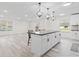 Open-concept kitchen with a large island, sleek countertops, and modern pendant lighting at 2815 Kay Ellen Dr, Indianapolis, IN 46229