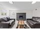 Spacious living room with a brick fireplace, plank flooring, and lots of natural light at 2815 Kay Ellen Dr, Indianapolis, IN 46229