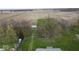 Aerial view of the property showcasing the house, creek, farmland, outbuildings, and surrounding landscape at 3335 W 400 N, Anderson, IN 46011