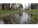 Picturesque creek flowing through the property with lush vegetation along the banks at 3335 W 400 N, Anderson, IN 46011