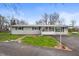 Charming single-story home with a well-maintained yard and enclosed front porch at 3335 W 400 N, Anderson, IN 46011