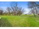Expansive lot featuring a lush lawn with scattered trees and small stream at 3335 W 400 N, Anderson, IN 46011