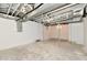 Unfinished basement features concrete floor, white walls, exposed ceiling, and support beams at 3516 N Capitol Ave, Indianapolis, IN 46208