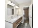 Bathroom showcasing a double sink vanity, modern fixtures, and open doorway to bedroom at 3516 N Capitol Ave, Indianapolis, IN 46208