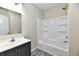 Clean bathroom with a vanity sink and a tub shower combo with white surround at 3516 N Capitol Ave, Indianapolis, IN 46208