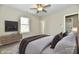 Bright bedroom with ceiling fan, large windows, and ensuite bathroom at 3516 N Capitol Ave, Indianapolis, IN 46208