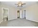 Bright bedroom showcasing two open doors, neutral walls, carpet, and a ceiling fan at 3516 N Capitol Ave, Indianapolis, IN 46208