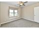 This cozy bedroom features plush carpeting, a ceiling fan, and a bright window nook at 3516 N Capitol Ave, Indianapolis, IN 46208