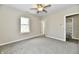 Comfortable bedroom with neutral paint, plush carpet, and an adjacent bathroom at 3516 N Capitol Ave, Indianapolis, IN 46208