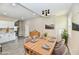 Open-concept dining area with stylish lighting, wood table set, and kitchen view at 3516 N Capitol Ave, Indianapolis, IN 46208